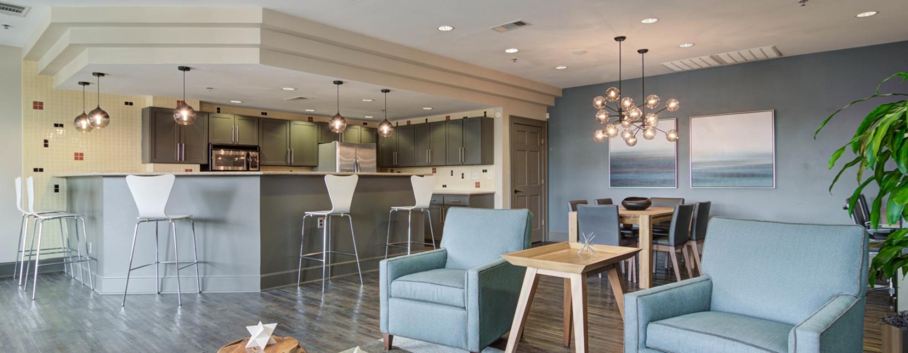 a living room with a bar and chairs