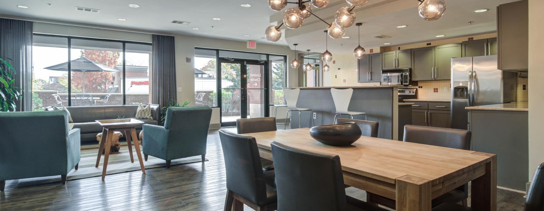 a large kitchen with a large chandelier over the dining table