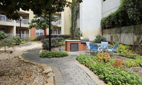 a patio with chairs and a table